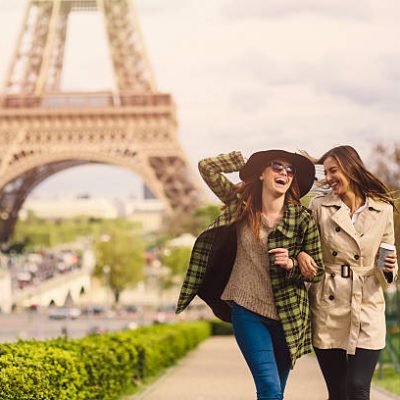 Two friends taking a walk around the Eiffel Tower in Paris.